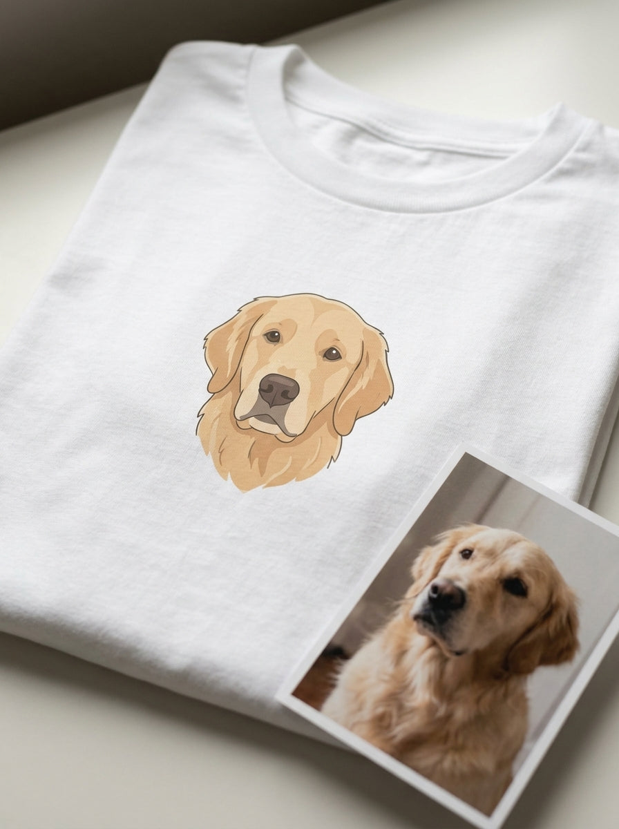 A pet portrait printed in full colour on a white t-shirt, with the owner's own photo of the golden retriever printed and lying beside it